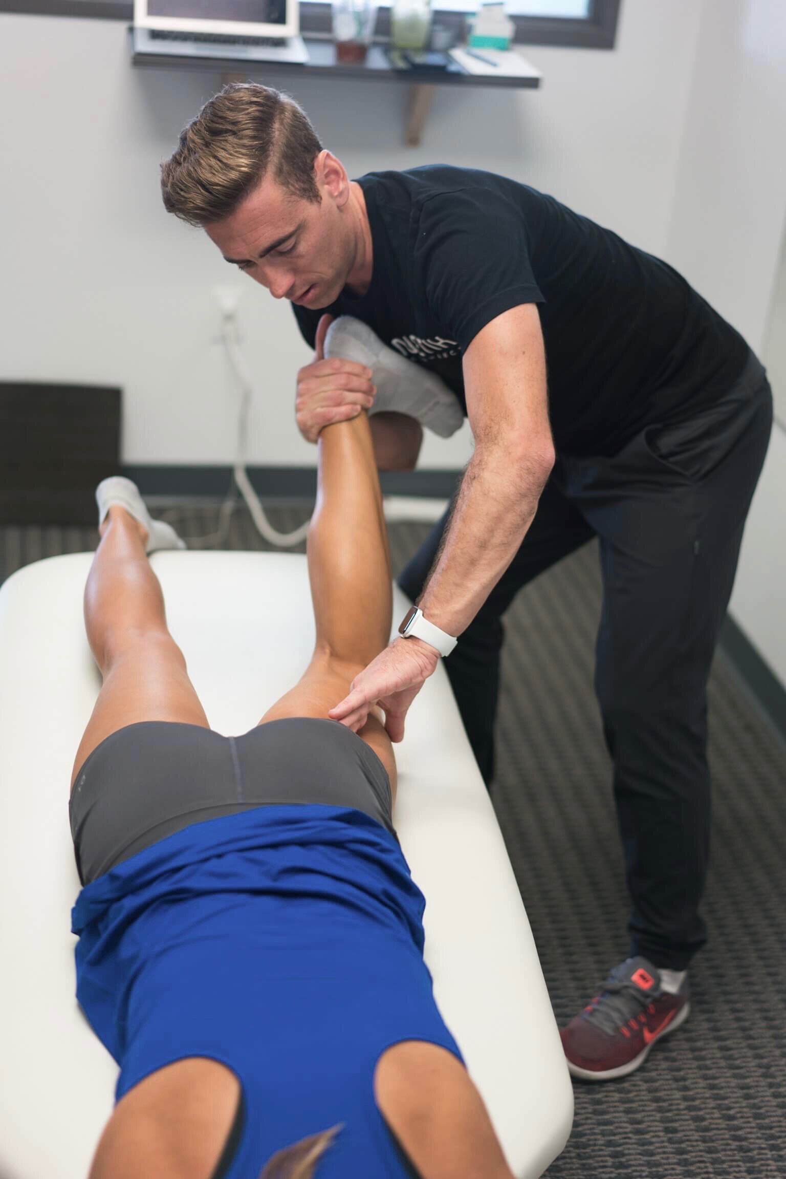 Therapist treating an athlete's leg